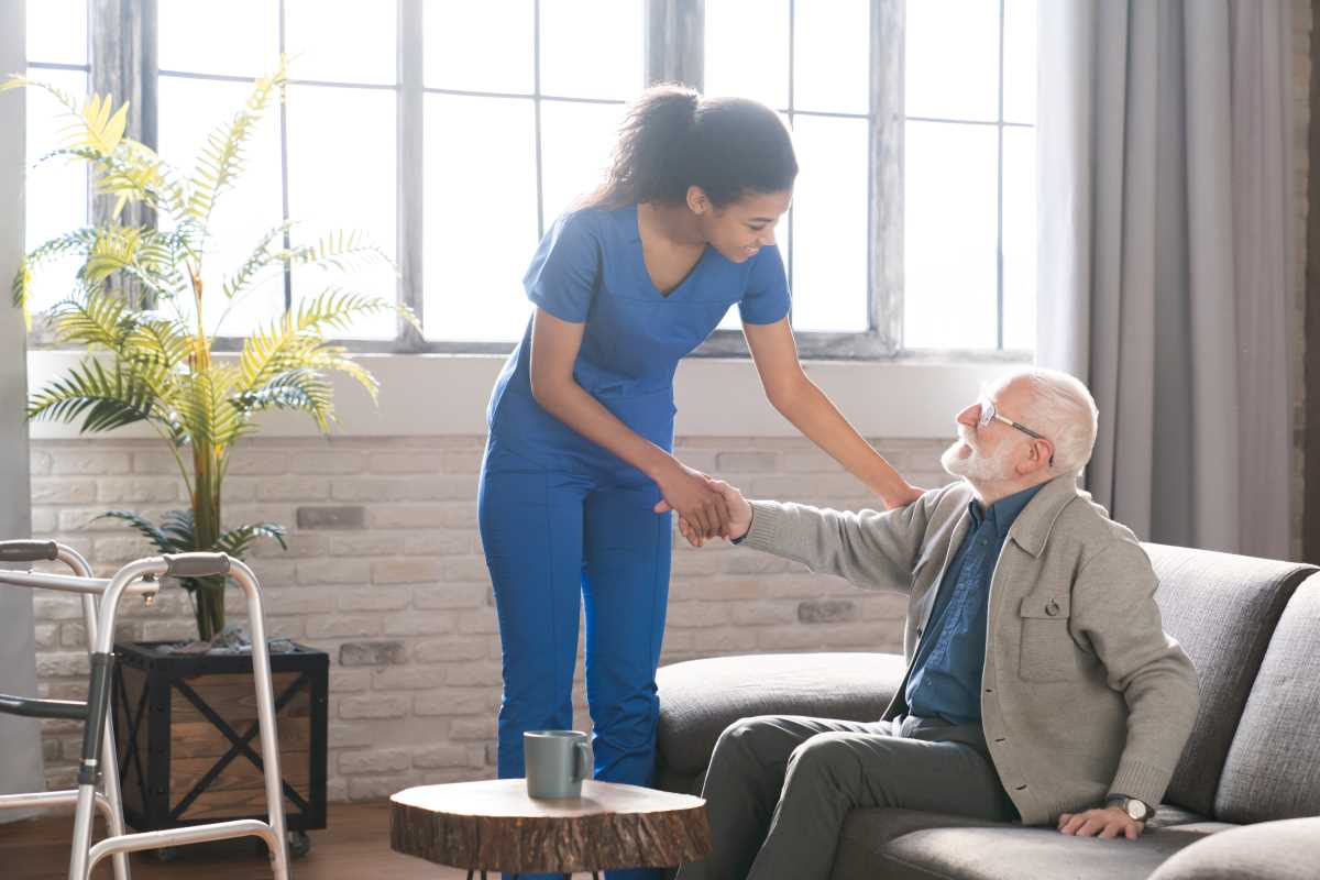 smiling woman doctor helping senior man